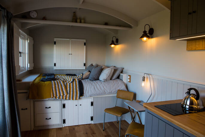 Unwind after a day at Tin and Wood in your cosy king-size bed at the end of your shepherd’s hut 