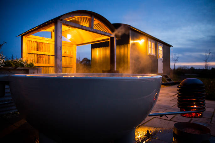 Relax in the outdoor hot tub at Tin and Wood in Leicestershire 