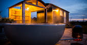 Relax in the outdoor hot tub at Tin and Wood in Leicestershire 