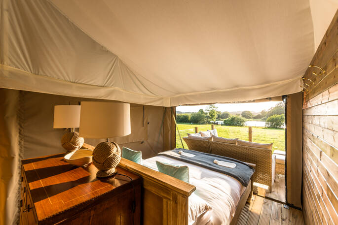 Spend your mornings lying in bed watching the wildlife go by inside your safari tent at The Nest