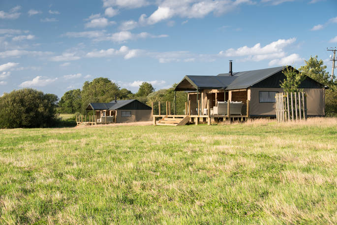 Both safari tents next to the lake at The Nest in Lincolnshire 