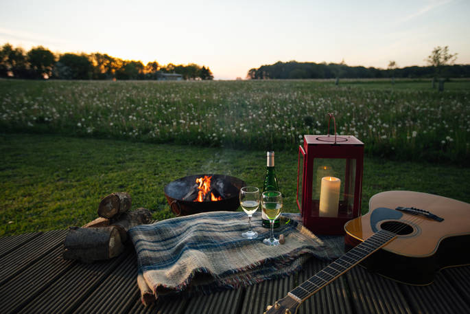 Relax with a glass of wine on the Oyster Catcher decking and watch the sunset at Bagthorpe Farm in Norfolk