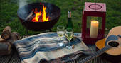 Relax and unwind by the fire pit at the Woodcock Cabin in Norfolk