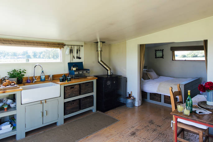 The perfectly fitted Woodcock Cabin with full kitchen and cosy bedroom space at Bagthorpe Farm in Norfolk
