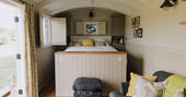 King-size bed inside Cowslip shepherd's hut at Honey Pot Meadow at Wild With Nature