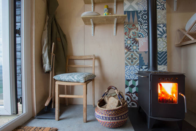 Light the wood-burner and enjoy sea views from your hut in Northumberland 