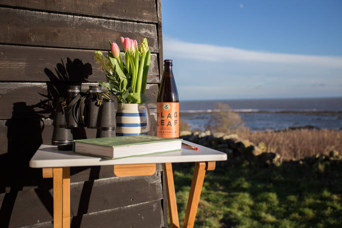 Sit outside the hut and read a book whilst enjoying the sea view in Northumberland