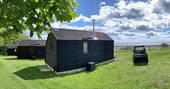 The beautiful black wood exterior of the Alnmouth Huts in Northumberland