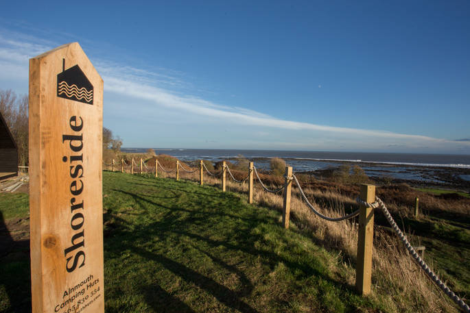 Alnmouth camping huts wooden sign in Northumberland