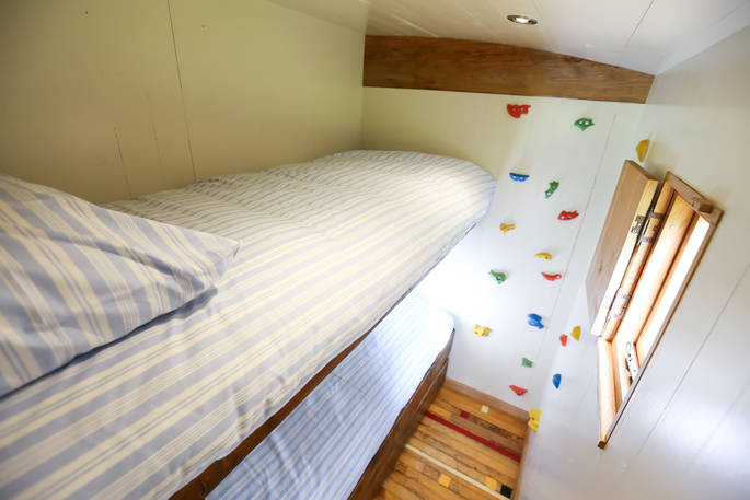 Bunk room with a climbing wall