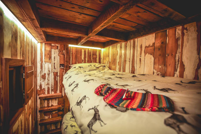 Bunk beds for the kids tucked away under Rowan cabin's mezzanine level in a cool cubbyhole