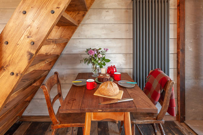 Lottie's Cabin - dining table under the stairs, Hillside Huts & Cabins, Morpeth, Northumberland
