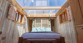 Lay in the king-size bed and look up at the stars inside Cheviot at Huts in the Hills in Northumberland