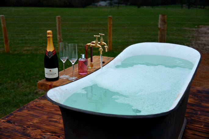 Relax in the outdoor bath tub at Cheviot and sip a glass of bubbly whilst enjoying the views of Northumberland 
