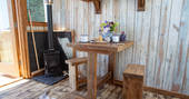 Sit by the wood-burner inside Cheviot at Huts in the Hills in Northumberland 