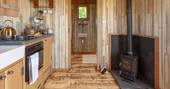 Sit by the wood-burner inside Dunmore at Huts in the Hills in Northumberland