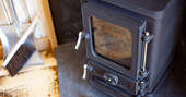 Wood-burner inside Dunmore shepherds hut  at Huts in the Hills in Northumberland
