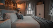Silver and white interiors of the bedroom at The Waiting Room in Northumberland
