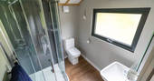 Bathroom facilities including shower and flushing toilet inside your safari lodge at Bird Holme Glamping in Nottinghamshire