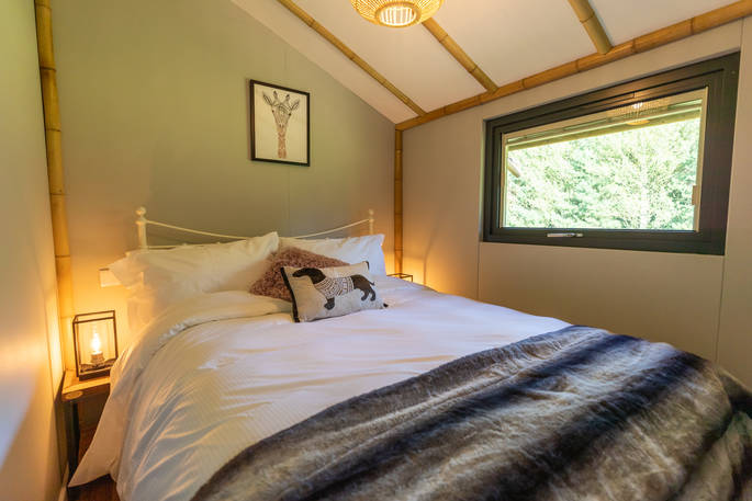 Cosy double bed inside your safari lodge at Bird Holme Glamping in Nottinghamshire