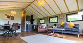Open plan living area and fully equipped kitchen inside your safari lodge at Bird Holme Glamping in Nottinghamshire
