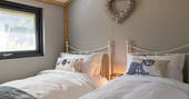Two single beds inside your safari lodge at Bird Holme Glamping in Nottinghamshire