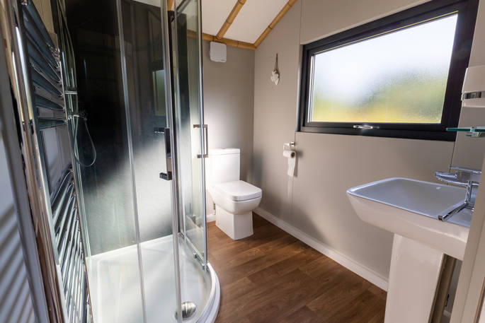 Bathroom facilities including shower and flushing toilet inside your safari lodge at Bird Holme Glamping in Nottinghamshire