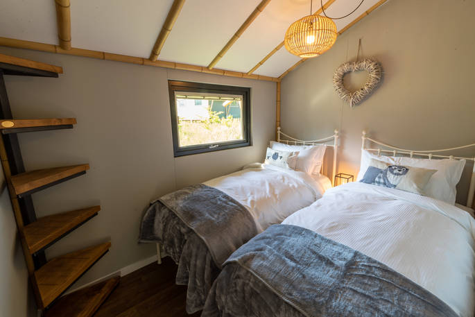 Two single beds inside your safari lodge at Bird Holme Glamping in Nottinghamshire