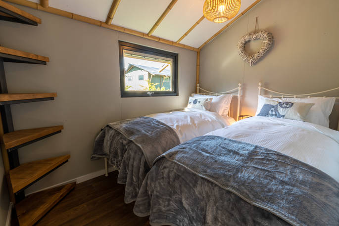 Two single beds inside your safari lodge at Bird Holme Glamping in Nottinghamshire