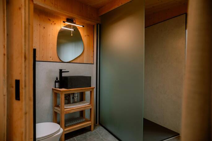 Bathroom with hot shower, sink and flushing toilet