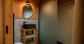 Bathroom with hot shower, sink and flushing toilet