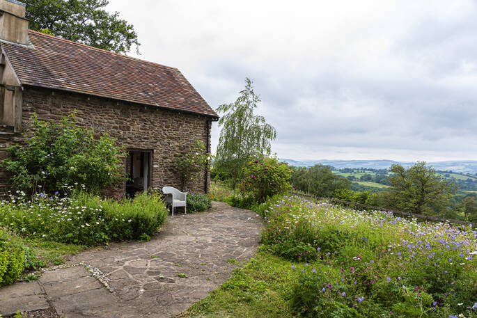 Sit outside of Damson Cottage and enjoy the views overlooking Shropshire 