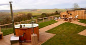 Oak Hut at Shropshire Shepherds Huts garden with a fire pit area and hot tub
