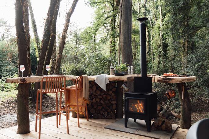 Breakfast bar next to the wood burner stove and grill