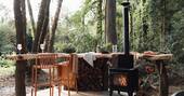 Breakfast bar next to the wood burner stove and grill