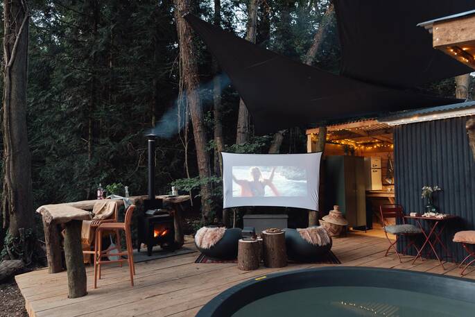 Outdoor space with cinema area, hot tub, outdoor shower and breakfast bar