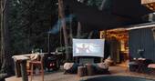 Outdoor space with cinema area, hot tub, outdoor shower and breakfast bar