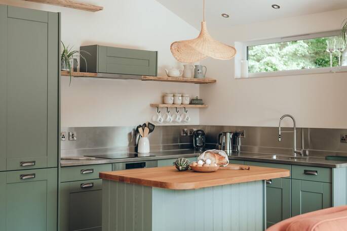 Kitchen equipped with an oven microwave, kettle, and full fridge
