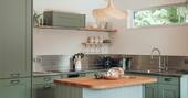 Kitchen equipped with an oven microwave, kettle, and full fridge