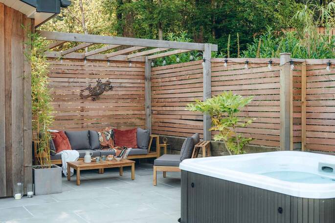 Patio with outdoor seating and a hot tub