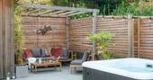 Patio with outdoor seating and a hot tub