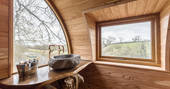 Stone wash basin in Cheriton Treehouse bathroom with views of the surrounding Somerset countryside 