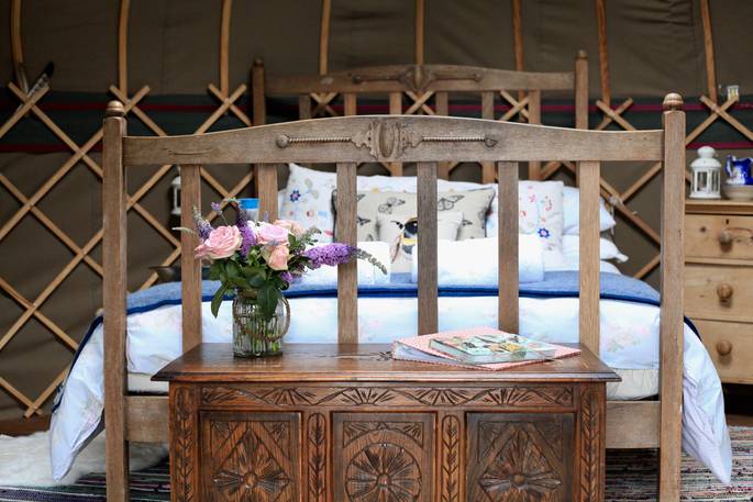 Double bed and fresh flowers at Deers Leap Yurt, Somerset