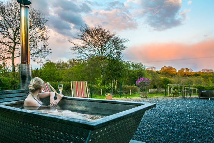 Drink champagne and relax in the outdoor hot tub at Dimpsey in Somerset 