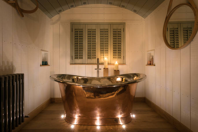 Roll top bath inside Dimpsey Yonder Shepherd's Hut in Somerset