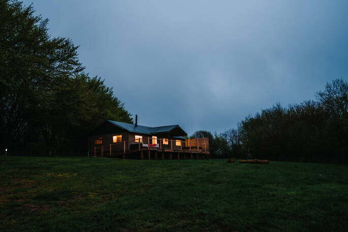 Exterior view of the two safari tents in the evening
