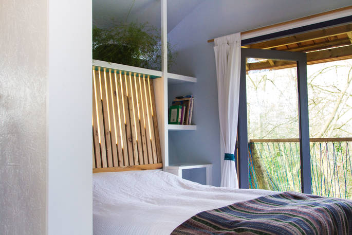 Double bed tucked around the corner in Orchard Rooms Treehouse in Somserset