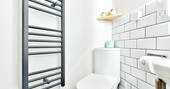 Flushing toilet and towel rail in the bathroom