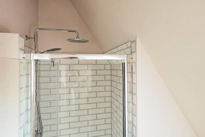 Bathroom with a hot shower, sink and flushing toilet
