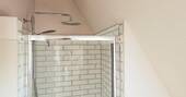 Bathroom with a hot shower, sink and flushing toilet